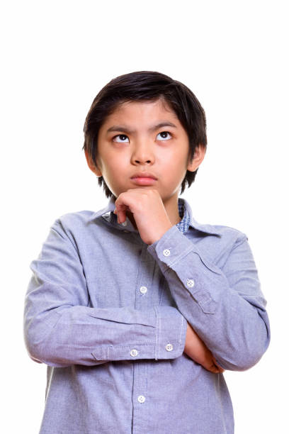 istock Studio shot of cute Japanese boy thinking while looking up 669184852