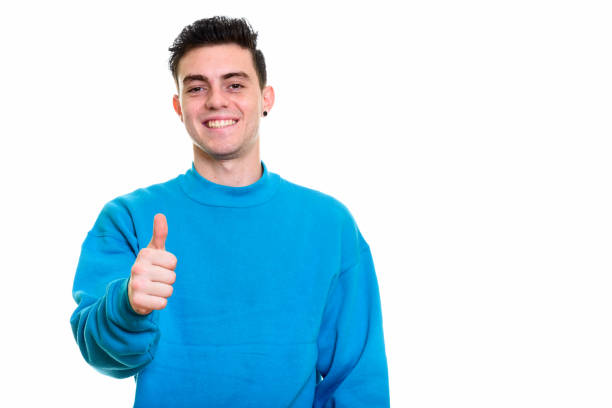 istock Happy young man smiling and giving thumb up 669188356