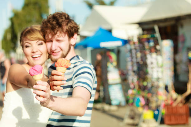 istock young couple eating ice cream outdoor 669190802