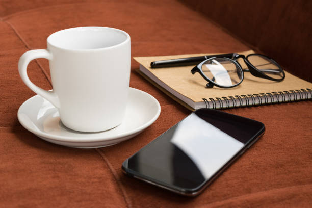istock Cup,cup of coffee and smartphone with diary note on red carpet or sofa background 669196736