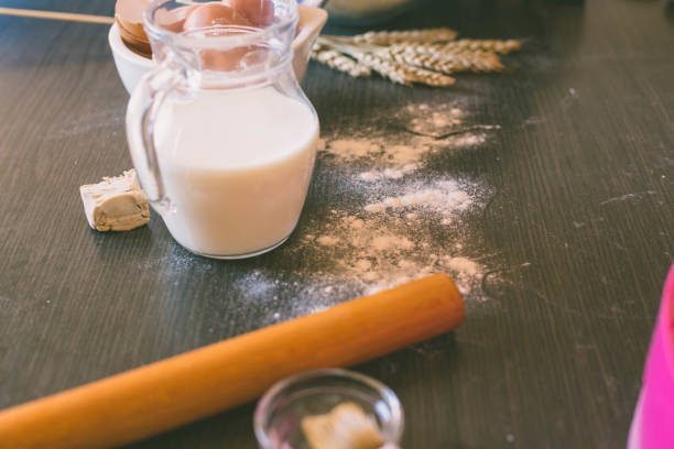 istock The process of baking, cooking. Flour, rolling pin, whisk, egg shells mesh. Pile the flour into a bowl with the egg yolk and milk in a jug. Top view, space for text 669197344