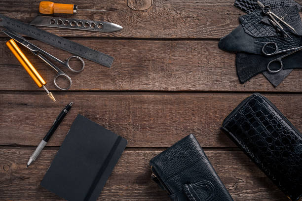 istock Leather craft or leather working. Leather working tools and cut out pieces of leather on work desk 669199924