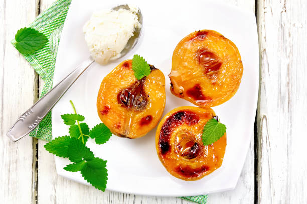 istock Quince baked with ice-cream and mint in plate on board top 669200310