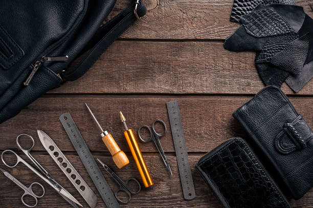 istock Leather craft or leather working. Leather working tools and cut out pieces of leather on work desk 669200472