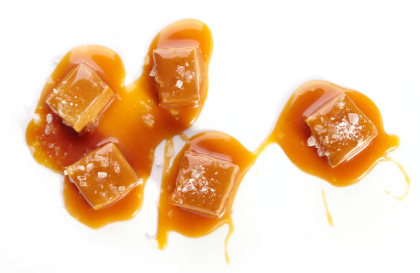 homemade salted caramel pieces homemade salted caramel pieces isolated on white background, top view caramel stock pictures, royalty-free photos & images