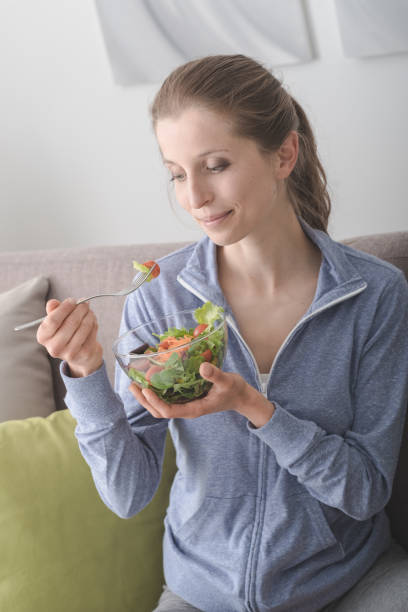 istock Young woman having lunch at home 669210436