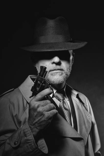istock Detective holding a gun in the dark 669220156