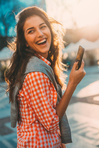istock Beautiful woman texting outdoors 669220282