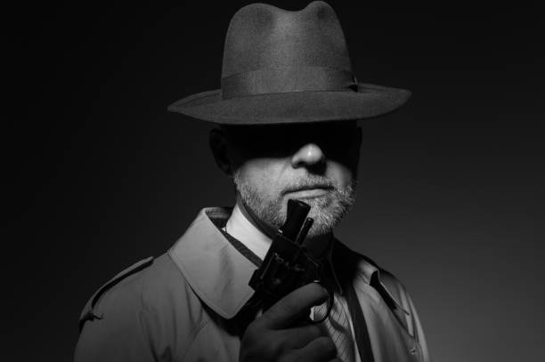 istock Detective holding a gun in the dark 669220382
