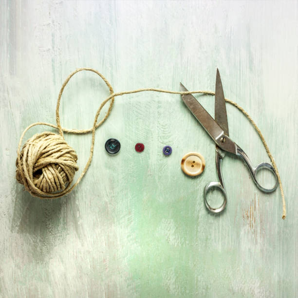 istock Vintage scissors, roll of twine and buttons, with copyspace 669220556