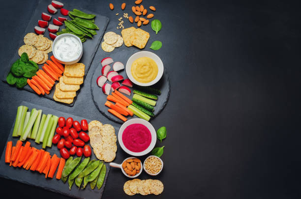 istock Variation of healthy vegan snacks. Vegetables, crackers, dip and hummus 669222880