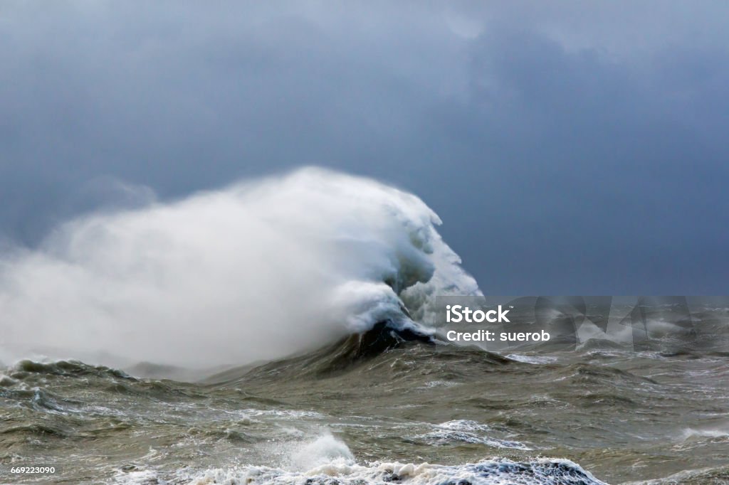 Waves Forming Face High tide at Newhaven, East Sussex, during Storm Doris in February 2017. Waves in rough sea forming face-like appearance in the strong wind. 2017 Stock Photo