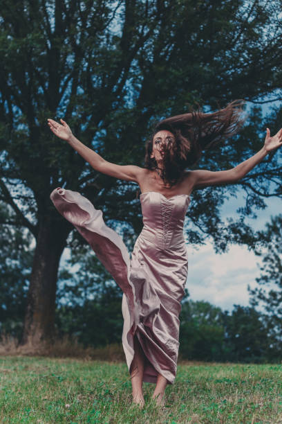 istock young woman in a dress 669223310