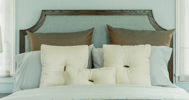 istock cozy bedroom interior with white pillows and reading lamp on bedside table 669223606