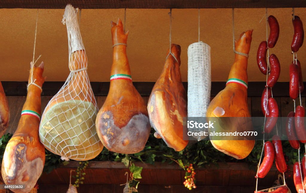 Parma Ham hanging in a delicatessen shop in Italy Hanging Stock Photo