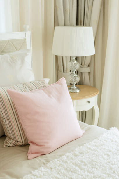 istock luxury bedroom interior with pink pillows and reading lamp on bedside table 669224074