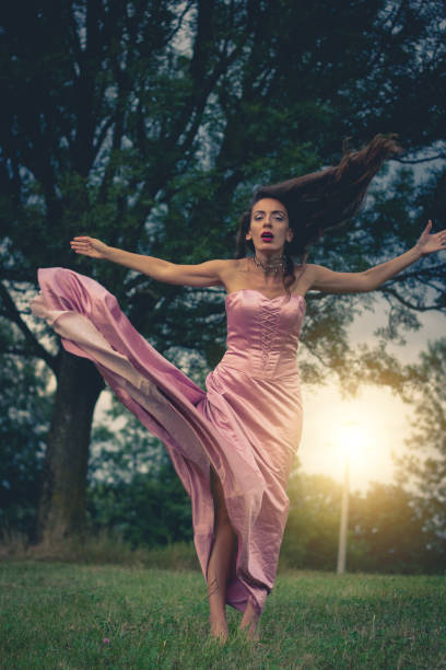 istock young woman in a dress 669226630