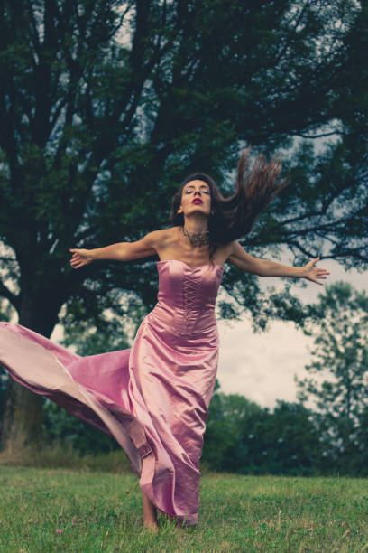 istock young woman in a dress 669226980