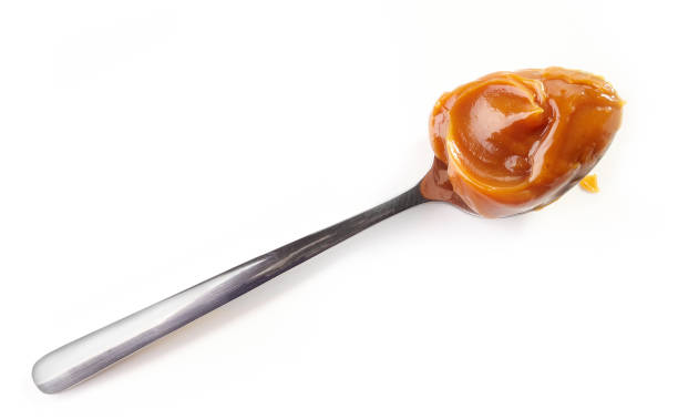istock spoon of soft homemade caramel 669227366
