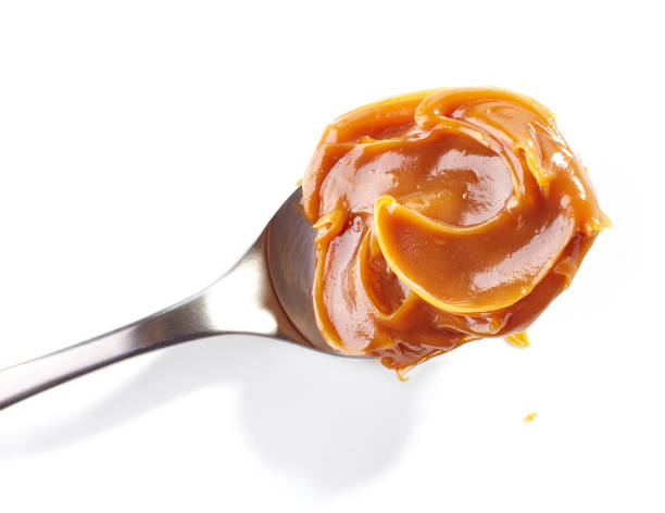 istock spoon of soft homemade caramel 669227372