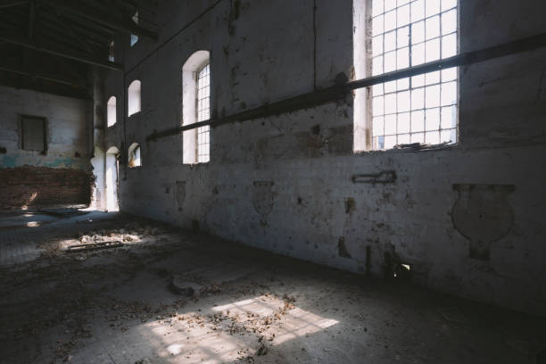 istock Dark, old, spooky abandoned building interior, with sunlight comes through windows 669230486