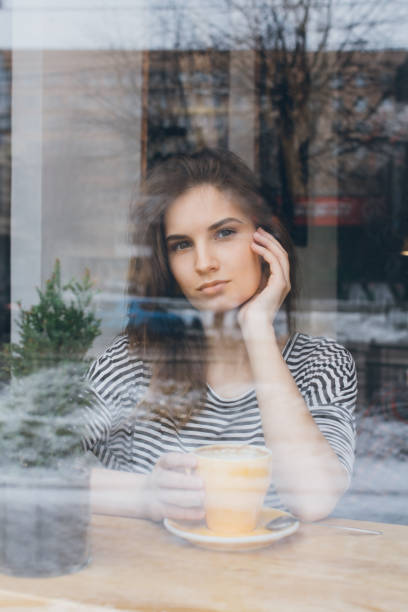 istock Girl drinking coffee in a coffee shop 669237116