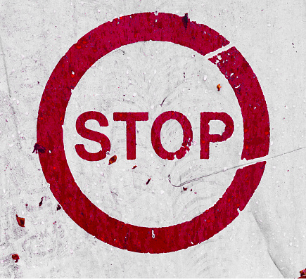 Grunge stop sign white and red colours on street road