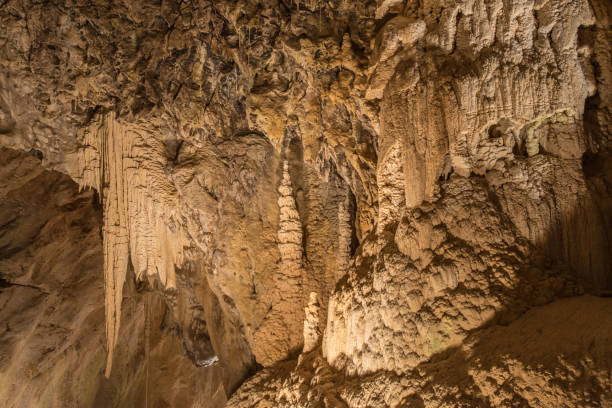 Cave Cave with dripstones near Vallorbe, Switzerland. Grotto known as "Fairy cave". bär stock pictures, royalty-free photos & images