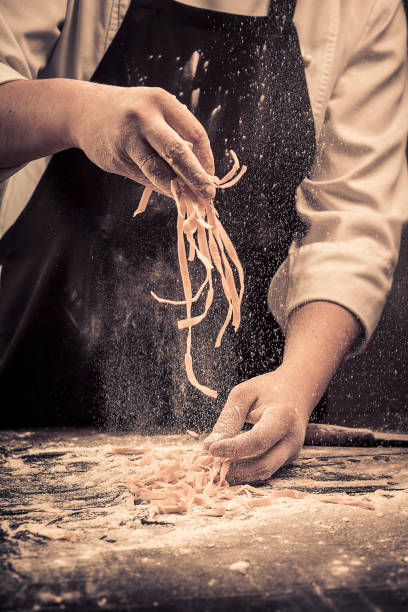 The chef makes fresh spaghetti from scratch