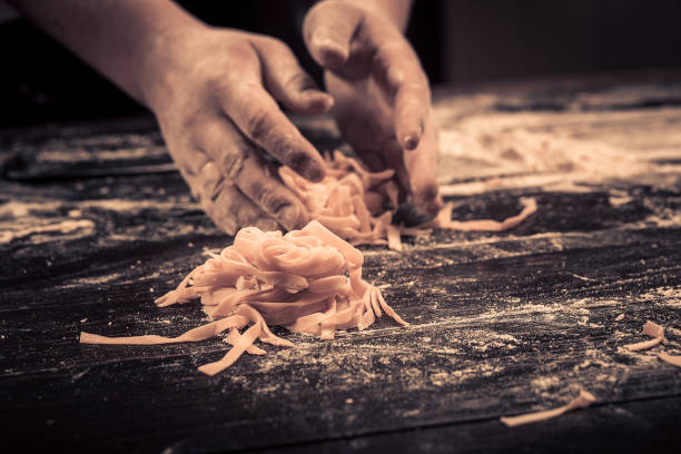 The chef makes fresh spaghetti from scratch
