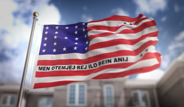 istock Bikini Atoll  Flag 3D Rendering on Blue Sky Building Background 669246906