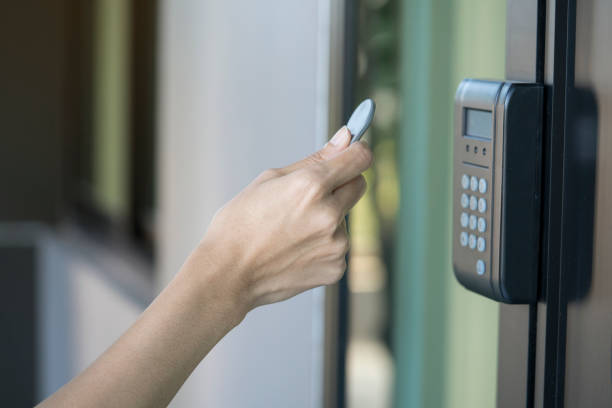 young woman using RFID tag key to open the door young woman using RFID tag key to open the door radio frequency identification stock pictures, royalty-free photos & images