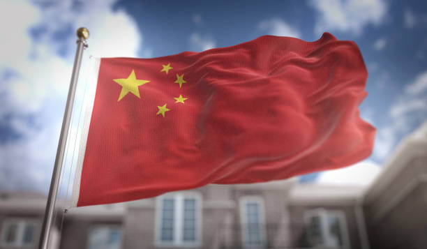 istock China Flag 3D Rendering on Blue Sky Building Background 669247168