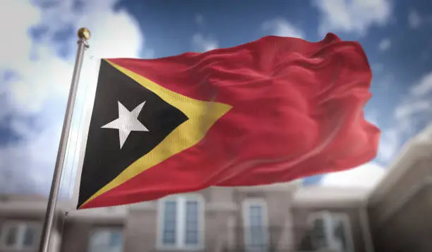 East Timor Flag 3D Rendering on Blue Sky Building Background