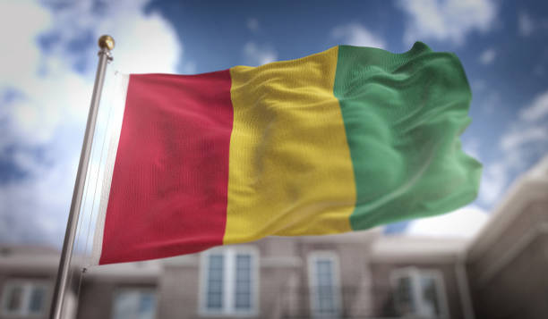 istock Guinea Flag 3D Rendering on Blue Sky Building Background 669250274