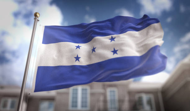 honduras flag 3d rendering on blue sky building background - tegucigalpa imagens e fotografias de stock