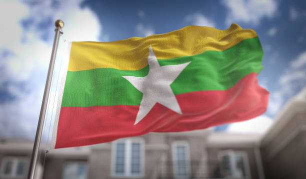 renderização 3d de mianmar bandeira sobre fundo azul céu edifício - burmese flag - fotografias e filmes do acervo