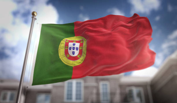istock Portugal Flag 3D Rendering on Blue Sky Building Background 669254476