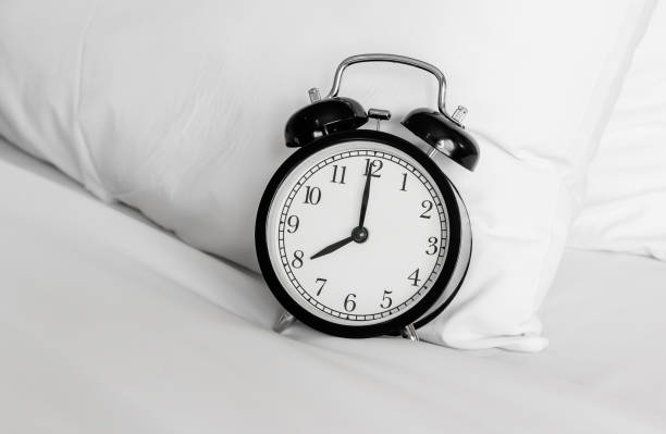 istock Still life with vintage alarm clock on bed ( alarm clock show 8 o`clock ) 669257342