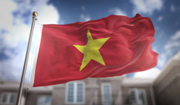 istock Vietnam Flag 3D Rendering on Blue Sky Building Background 669259600