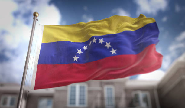 istock Venezuela Flag 3D Rendering on Blue Sky Building Background 669259604
