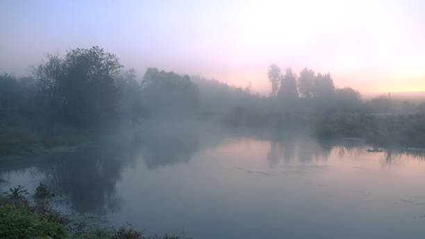 istock Foggy autumn landscape with small forest river 669259834