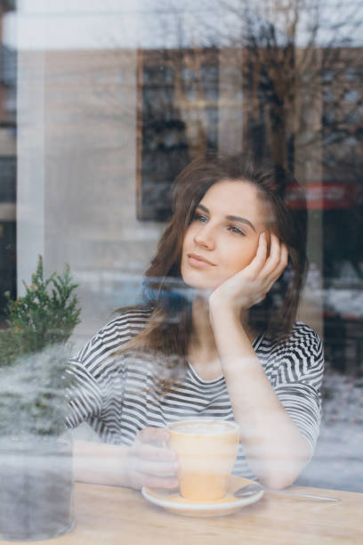 istock Girl drinking coffee in a coffee shop 669266418