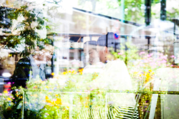 Japanese senior women in cafe, window reflection.