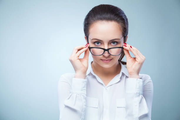 istock woman with glasses on light background 669274642