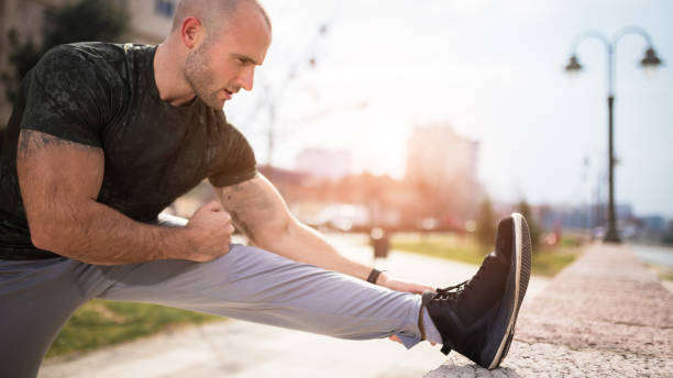 istock Young athletic man stretching outdoors 669278220