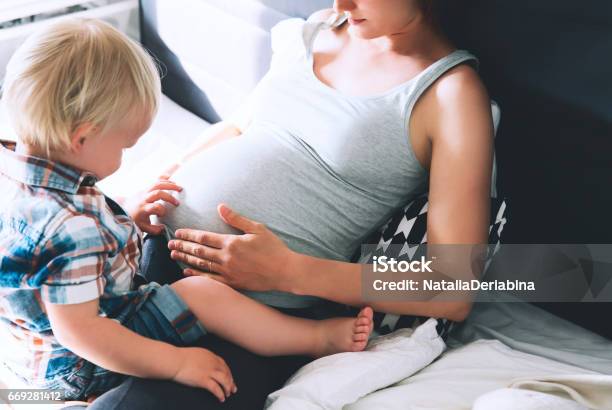 Pregnant Mother And Son At Home Stock Photo - Download Image Now - Pregnant, Child, Women