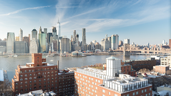 An aerial photograph of the New York City Skyline along with the historic buildings of Brooklyn Heights and the world famous Brooklyn Bridge in the foreground.