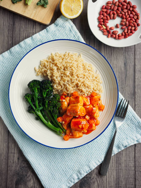 Home made gong po chicken(sour and hot)chicken with brown rice and freshness poached purple sprouting broccoli and roasted peanuts.