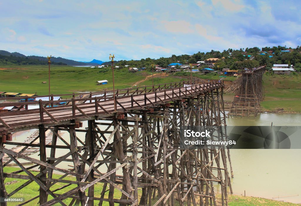 Beautiful sunset scene at old an long wooden bridge Beautiful sunset scene at old an long wooden bridge at Sangklaburi,Kanchanaburi province, Thailand Architecture Stock Photo